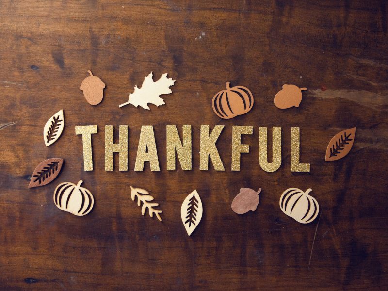 Wooden background with the word thankful
